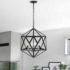 a chandelier hanging from the ceiling in a dining room