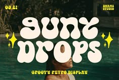 the sun drops font is displayed in front of a swimming pool