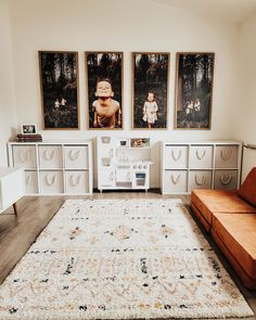 a living room filled with lots of furniture and pictures on the wall above it's couch