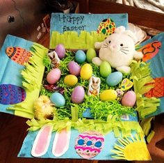 a basket filled with lots of colorful eggs and an easter bunny sitting on top of it