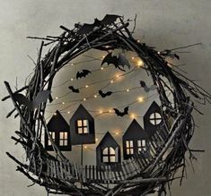 a halloween wreath with bats and houses on it