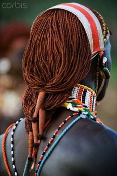 an african woman with dreadlocks on her head and braids in her hair