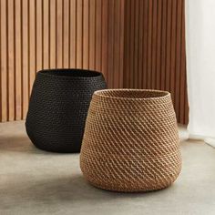 two black and brown baskets sitting next to each other