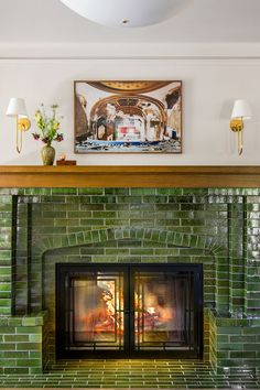 a living room with a fire place and bookshelves on the wall above it