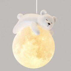 a light that is shaped like a polar bear sleeping on the moon with its eyes closed