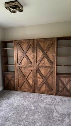 an empty room with wooden doors and shelves