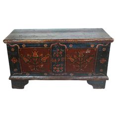 an old wooden chest with painted designs on it