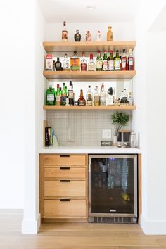 a kitchen with shelves filled with liquor bottles