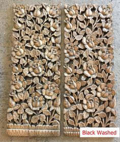 two carved wooden panels with flowers on them