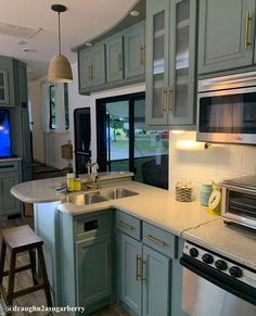 a kitchen with blue cabinets and white counter tops