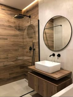 a bathroom with a sink, mirror and shower