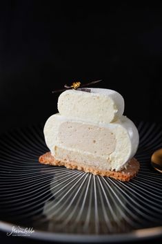 a piece of cake sitting on top of a black plate