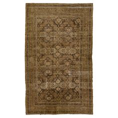 an antique rug with brown and tan colors