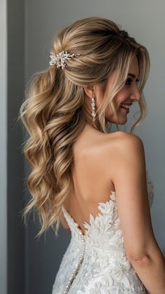 a woman with long hair wearing a wedding dress and diamond headpiece in her hair