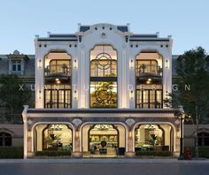 a large white building with lots of windows and lights on it's front entrance