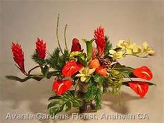 a vase filled with red and yellow flowers