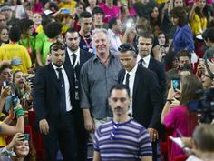 a group of people standing next to each other in front of a crowd with cameras