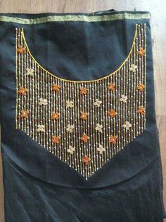 an embroidered bag sitting on top of a wooden floor