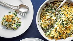 two plates with food on them and silverware next to each other in front of blue table cloth