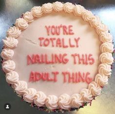 a cake with writing on it that says you're totally nailing this adult thing