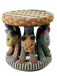 an artistically designed stool with three cats on it