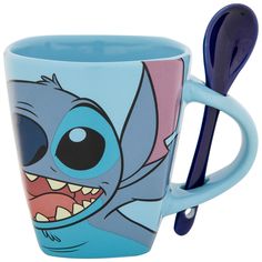 a blue coffee cup with an image of stitcher and toothbrush in it's mouth