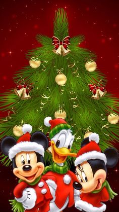 two mickey and minnie mouses in front of a christmas tree with the caption for google