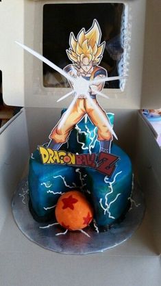 a dragon ball cake sitting on top of a counter next to a microwave oven with the door open