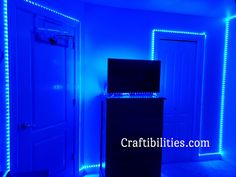 a room that has some lights on the walls and blue lighting around it is lit up