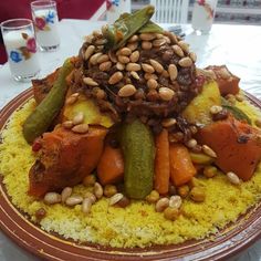 a plate with beans, carrots and other food on it sitting on a table