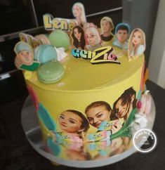 a yellow cake with pictures of people on it