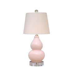 a pink lamp with a white shade on it