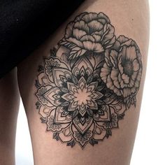 a woman's thigh with black and white flowers on it