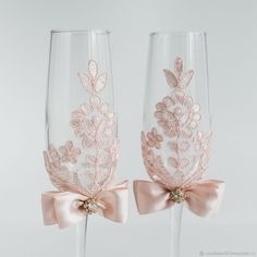 two wine glasses with bows and lace on them