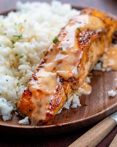 a plate topped with rice and meat covered in gravy