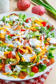 a white plate topped with salad covered in dressing