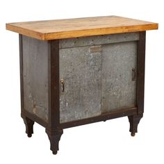 an old metal cabinet with wooden top