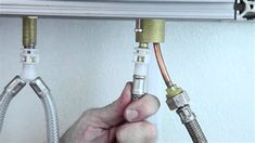 a man is fixing an electrical outlet with two wires attached to the wall above him