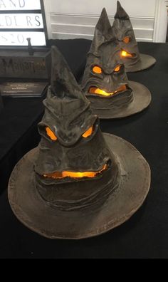 three halloween hats with glowing eyes on them