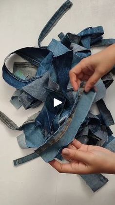 someone is cutting up some old jeans with scissors