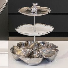 two tiered trays with silver dishes on them