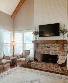 a living room filled with furniture and a flat screen tv mounted on the wall above a fire place