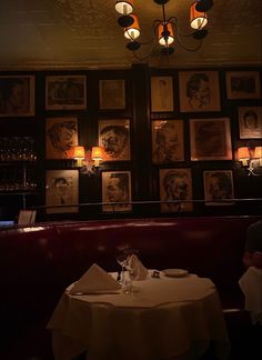 a dimly lit restaurant with pictures on the wall