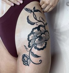 a woman with a tattoo on her thigh