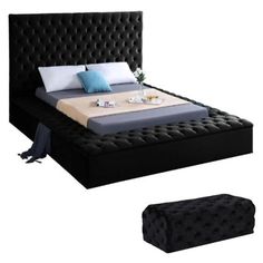 a bed with black headboard and foot board in front of white background, next to an ottoman