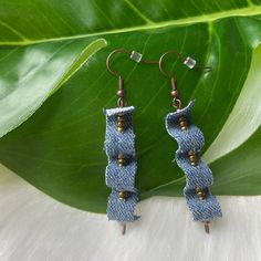 These Fun Shabby Chic Denim Earrings Will Be A Fun Accessory To Your Next Outfit! They Are Handmade From Upcycled Blue Jeans - & Bronze Tone Seed Beads - Hung On A Nickel Free Bronze Jewelry Hook/Wire & Accented By A Matte Metal Seed Bead. They Hang Apx 2” & Make For The Perfect Fun Boho Accessory! Smoke/Pet Free Home Tags- Blue Earrings, Coastal Earrings, Modern Earrings, Statements Earrings, Y2k Jewelry, Y2k Earrings, Tropical Earrings, Pop Earrings, Contemporary Earrings, Art Earrings, Shabby Chic Earrings, Blue Jean Earrings, Y2k Earrings Floral Earrings, Anthropology Jewelry, Anthropology Earrings, Art Deco Earrings, Minimalist Earrings Anthropology Earrings, Handmade Artsy Blue Beaded Earrings, Blue Jean Earrings, Anthropology Jewelry, Denim Jewelry Leaves Earrings, Blue Denim Earrings As A Gift, Fabric Earrings Handmade, Blue Handmade Novelty Earrings, Unique Blue Earrings With Dangling Beads