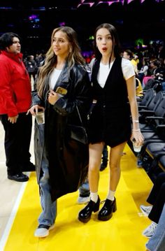 two girls walking down the court at a basketball game