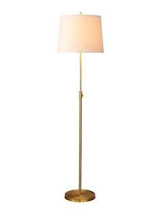 a gold floor lamp with a white shade on the base and a light bulb at the end