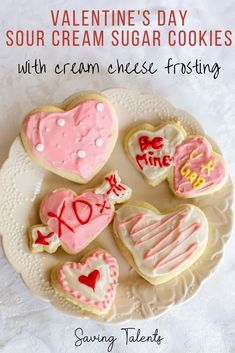 valentine's day sour cream sugar cookies with cream cheese frosting on a plate