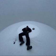 a man laying on top of a snow covered ground